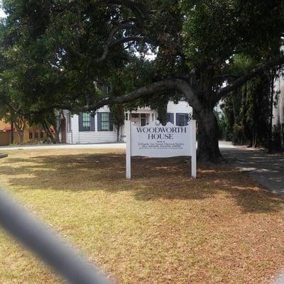 Front of house with sign.