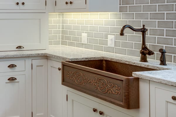 beautiful cooper sink tiled back splash under cabinet lighting