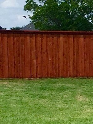 Board on board with cap and trim in redwood stain