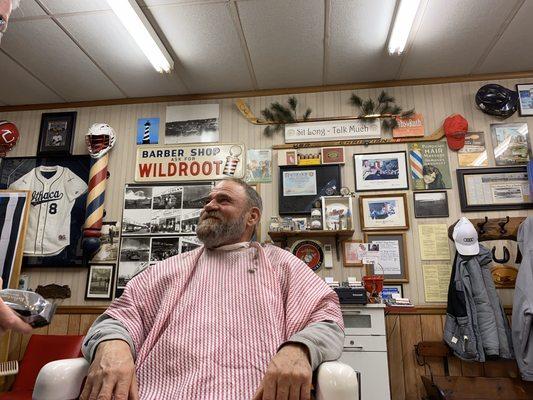 Loyal customer getting a haircut and beard trim.