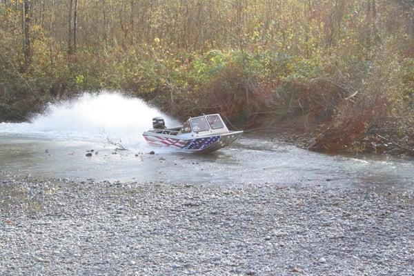 A Wooldridge 17' Alaskan outboard jetboat running shallow.