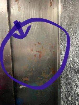 Handprint if death inside the elevator.