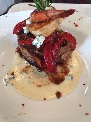 Filet wrapped in bacon with shrimp and red peppers in a Gorgonzola cream sauce