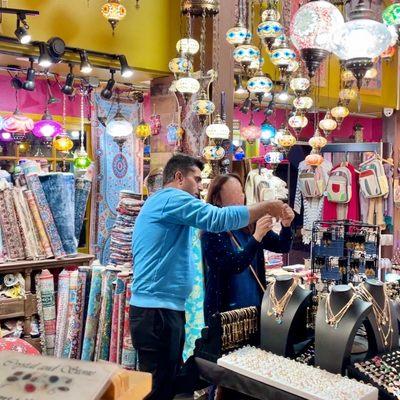 The store sales helping my wife picking out bracelets.