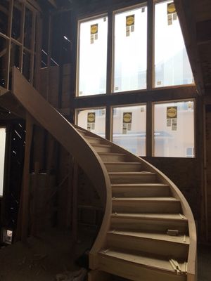 Round staircase in center of house with windows that are 10' Wide by 18' long