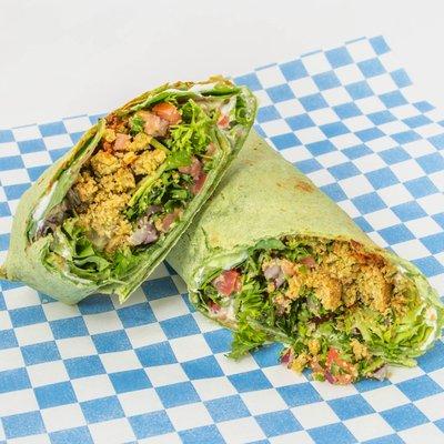 Falafel - Vegetarian Falafel, tzatziki, roasted garlic hummus, field greens, cucumber, parseley, tomato, onion in toasted tortilla