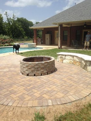 Pavers are the perfect compliment to your pool deck or to cover up a plain concrete pad.  Adding seating and a fire pit makes it even better