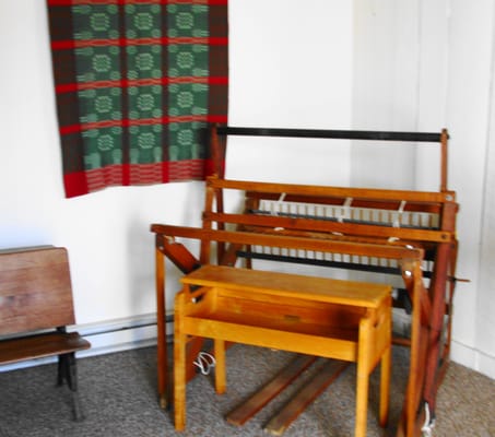 a weaving loom and woven wall hanging