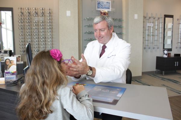 Dr. Cohen fitting a pair of precious eyes with new glasses