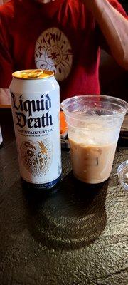 Liquid Death water, and a yummy White Russian