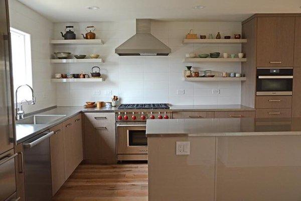 Custom Stainless Steel tops, floating shelves and a wolf range make this San Diego kitchen one of a kind.