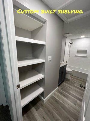 Custom refinished Bathroom with custom storage shelving.