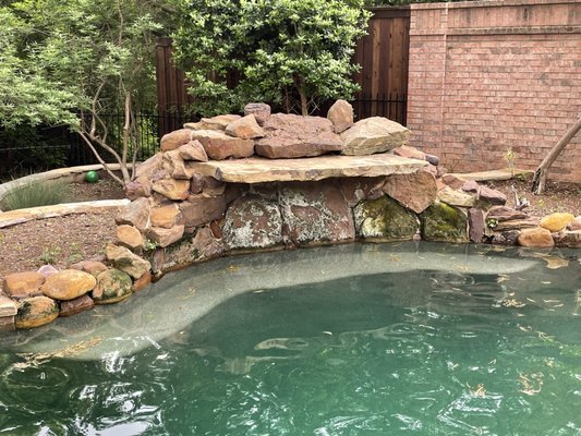 Before-Residential power washing of pool deck and waterfall. Remove algae and moss then remove calcium and mineral stains in Coppell, Texas.