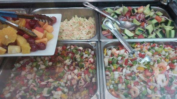 Ceviches, fruit salad, slaw, and cucumber salad