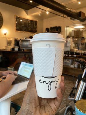 Large To-go cup of lavender honey oat milk latte