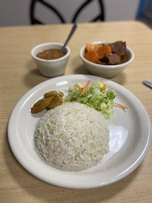 Beef stew with white rice, salad, beans and maduros. $12