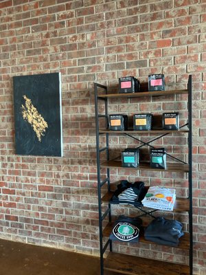 Merch and coffee beans available for purchase in-store.