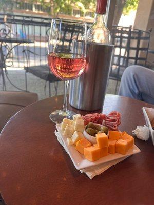 Meat and cheese tray with bottle of wine