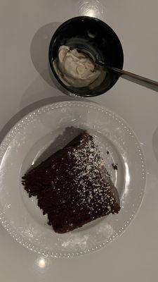 Dark chocolate cake & the tiniest "scoop" of vanilla ice cream I have ever seen!