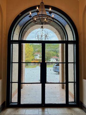 Iron french door with sidelights and transom for this front entry door.