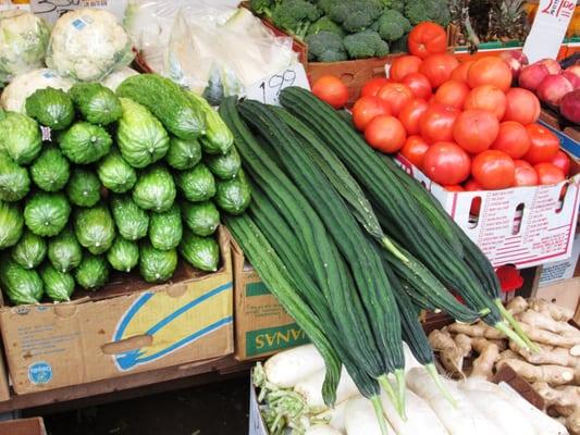 sidewalk display: bitter melon, Chinese okra, tomatoes, Chinese white radish, and ginger...