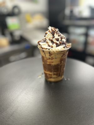 Caramel ice latte with chocolate drizzle, and whipped cream