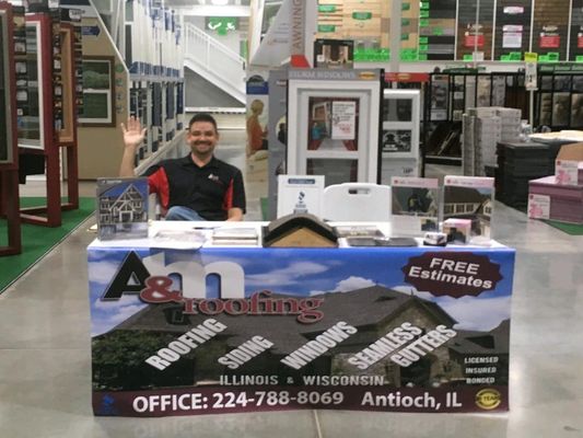 Owner Mike, seated at A&M Roofing booth.