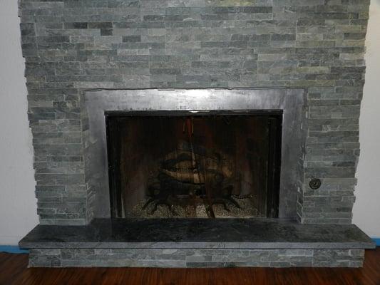 Ledge Stone tile installation around fireplace. With soapstone hearth already in place by customer.