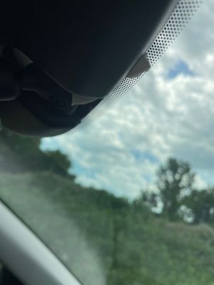 This is part of the hang tag that is stuck under the rear view to the windshield.