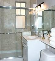 Marble showers with sliding glass door at The Regal