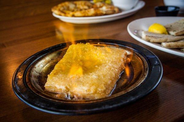 Tableside Flaming Saganaki, a House specialty! Imported flaming Kasseri cheese.