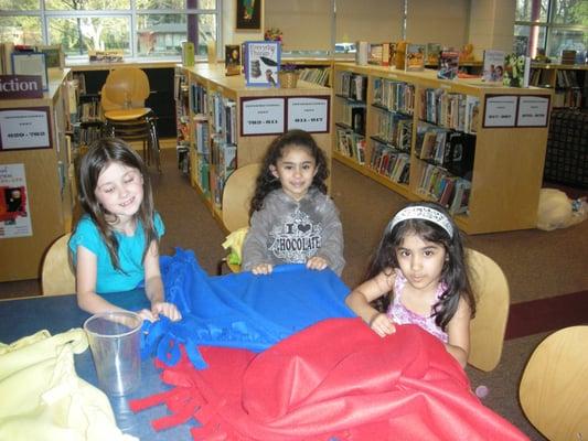 Kids volunteering and making no sew blankets for Project Night Night.