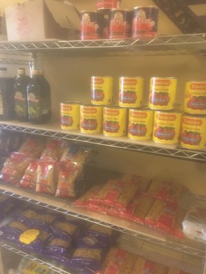 canned tomatoes, pasta, and oil for sale