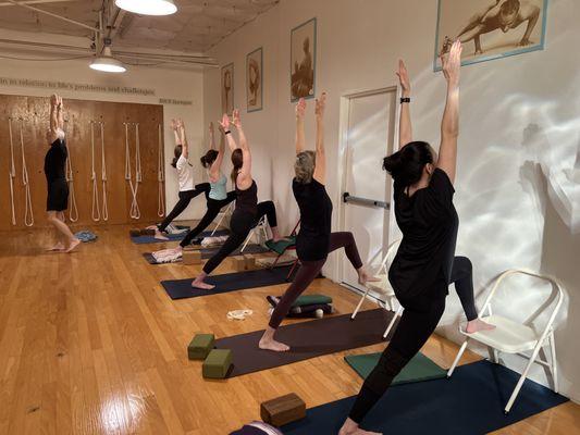 Larry Lane teaching Virabhadrasana I or warrior 1 on the chair