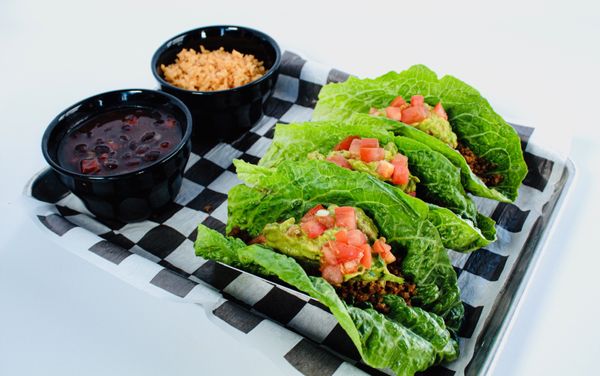 Lettuce wrap tacos - meat choice topped with fresh made guacamole and chopped tomatoes.