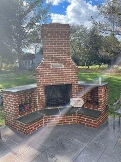 After picture of an example of what soft washing and power washing can do to your patio and outdoor fireplaces.