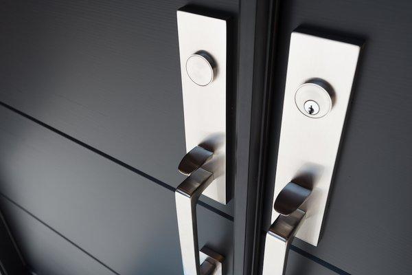 View of the entry door and hardware is a new modern house. 
   Diebel and Company | Architects 
   Kevin Ng Photography