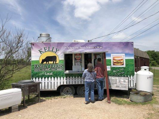 The food truck with the drink ice chests next to it