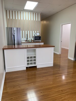 Kitchenette with a oversized sink, full refrigerator and microwave.