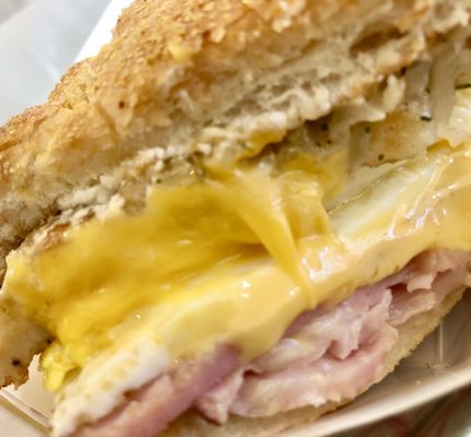 The Haystacker - a cross-section (Hoagie roll, American cheese, a potato pancake, fried eggs and ham). You can choose your bread and meat.