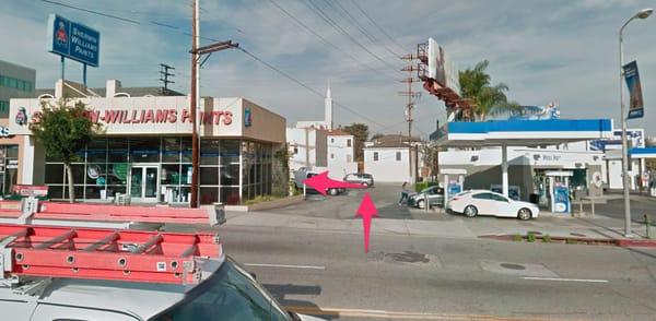 On Westwood Blvd. turn eastwards into the driveway between the Mobil Gas Station and Sherwin-Williams Paints, and then left into the alley.