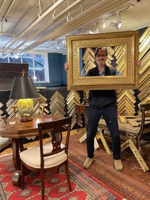 Dave showing off a 23 K custom gold leaf frame.